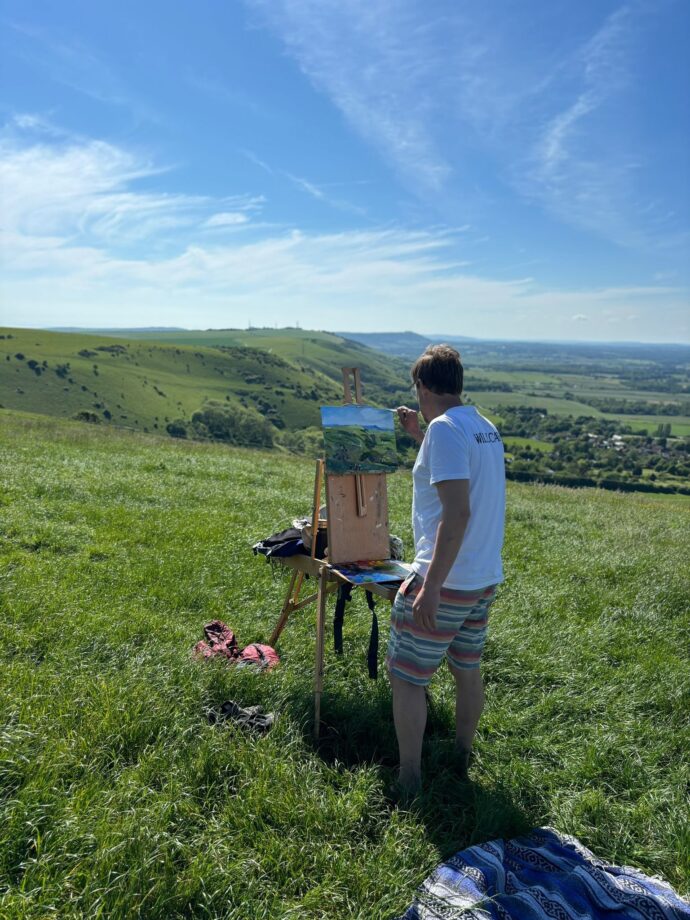 Photo of Jonny painting en plein air on the South Downs near Brighton
